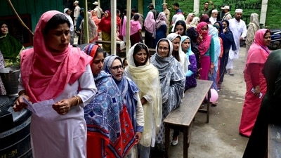 Women wait to cast their votes at a polling station during the first phase of the general election, in Imphal. (REUTERS)