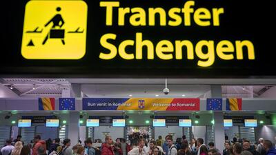 Passengers arriving at the Henri Coanda International Airport pass under a Schengen Information sign, in Otopeni, near Bucharest, Romania (AP) Passengers arriving at the Henri Coanda International Airport pass under a Schengen Information sign, in Otopeni, near Bucharest, Romania (AP)