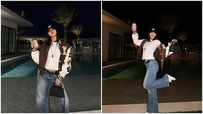 Lisa also shared another ensemble she wore during Coachella in the post. The post shows her posing in a white crewneck T-shirt featuring half-length sleeves and a fitted silhouette. She teamed the blouse with acid-washed light blue denim jeans featuring a flared hem and cinched with a black leather belt. Lastly, she completed the ensemble with a brown and white jersey jacket from Louis Vuitton, white sneakers, a baseball cap, a long chain, and an LV black bag. (Instagram) Lisa also shared another ensemble she wore during Coachella in the post. The post shows her posing in a white crewneck T-shirt featuring half-length sleeves and a fitted silhouette. She teamed the blouse with acid-washed light blue denim jeans featuring a flared hem and cinched with a black leather belt. Lastly, she completed the ensemble with a brown and white jersey jacket from Louis Vuitton, white sneakers, a baseball cap, a long chain, and an LV black bag. (Instagram)