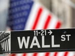 FILE PHOTO: FILE PHOTO: A street sign for Wall Street is seen outside the New York Stock Exchange (NYSE) in New York City, New York, U.S., July 19, 2021. REUTERS/Andrew Kelly/File Photo/File Photo