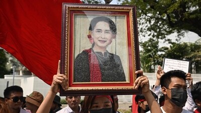 (FILES) Protesters hold an image of detained civilian leader Aung San Suu Kyi during a demonstration outside the UN office in Bangkok on February 1, 2024, to mark the third anniversary of the coup in Myanmar. Myanmar's junta has moved jailed democracy icon Aung San Suu Kyi from prison to house arrest, a source told AFP on April 17, 2024. (Photo by Lillian SUWANRUMPHA / AFP) (AFP) (FILES) Protesters hold an image of detained civilian leader Aung San Suu Kyi during a demonstration outside the UN office in Bangkok on February 1, 2024, to mark the third anniversary of the coup in Myanmar. Myanmar's junta has moved jailed democracy icon Aung San Suu Kyi from prison to house arrest, a source told AFP on April 17, 2024. (Photo by Lillian SUWANRUMPHA / AFP) (AFP)