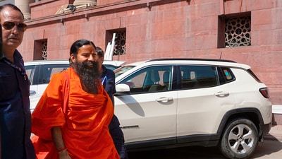 Ramdev arrives at the Supreme Court for hearing on the Patanjali misleading advertisements case. (PTI)