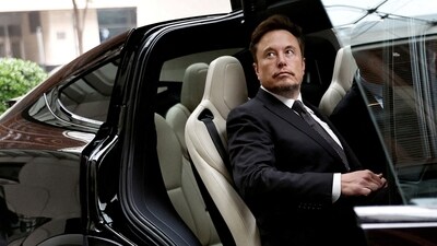 Tesla layoffs: Tesla Chief Executive Officer Elon Musk gets in a Tesla car as he leaves a hotel in Beijing, China. (Reuters)