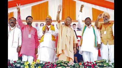 UP CM Yogi Adityanath waves to the supporters during a public meeting in support of BJP candidate from Amroha constituency Kanwar Singh Tanwar for Lok Sabha polls, in Amroha on Tuesday (ANI)
