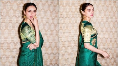 Aditi wore the silk six yards in traditional style, letting the pallu fall from her shoulder elegantly and pleating the saree on the front. She teamed it with a matching silk blouse featuring golden brocade embroidery, a round neckline, half-length sleeves, a fitted silhouette, and a cropped hem length. (Instagram) Aditi wore the silk six yards in traditional style, letting the pallu fall from her shoulder elegantly and pleating the saree on the front. She teamed it with a matching silk blouse featuring golden brocade embroidery, a round neckline, half-length sleeves, a fitted silhouette, and a cropped hem length. (Instagram)