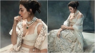 Kajal styled the lehenga set with a matching ivory-coloured chiffon dupatta decked in rose applique work and tassels on the borders. She layered it over her shoulders to complete the look. (Instagram) Kajal styled the lehenga set with a matching ivory-coloured chiffon dupatta decked in rose applique work and tassels on the borders. She layered it over her shoulders to complete the look. (Instagram)