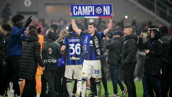 Inter Milan's French defender Benjamin Pavard (C) celebrates winning the 2024 Scudetto championship title (AFP)