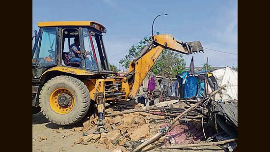 Ludhiana municipal corporation demolishing encroachments on the banks of Buddha Nullah on Tuesday. (HT Photo)