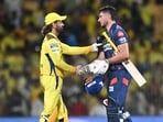 Lucknow Super Giants' Marcus Stoinis shakes hands with Chennai Super Kings' MS Dhoni (L) at the end of the Indian Premier League (IPL) Twenty20 cricket match between Chennai Super Kings and Lucknow Super Giants