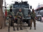 Security personnel stand guard in front of their armoured vehicle in Imphal, Manipur. (Reuters)