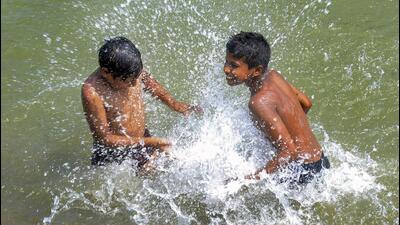 Chldrens play in water to beat the heat. (PTI) Chldrens play in water to beat the heat. (PTI)