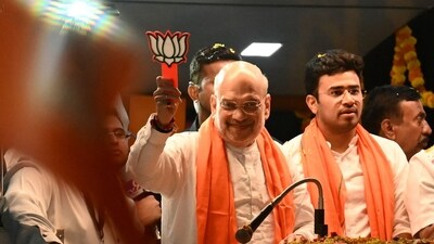 Union Home Minister Amit Shah during a roadshow in Bengaluru on April 23. (AFP) Union Home Minister Amit Shah during a roadshow in Bengaluru on April 23. (AFP)