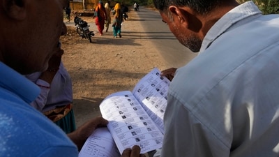 People check their names in voting list before casting their ballots during the first round of voting of India's national election in Neemrana, Rajasthan state, India, Friday, April 19, 2024. Nearly 970 million voters will elect 543 members for the lower house of Parliament for five years, during staggered elections that will run until June 1. (AP Photo/Manish Swarup) (AP) People check their names in voting list before casting their ballots during the first round of voting of India's national election in Neemrana, Rajasthan state, India, Friday, April 19, 2024. Nearly 970 million voters will elect 543 members for the lower house of Parliament for five years, during staggered elections that will run until June 1. (AP Photo/Manish Swarup) (AP)