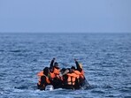 (FILES) Migrants travel in an inflatable boat across the English Channel, bound for Dover on the south coast of England. UK Prime Minister Rishi Sunak on April 22, 2024, promised to begin deporting asylum seekers to Rwanda in coming months as part of a plan to deter arrivals that has sparked controversy. 