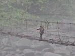 Police personnel crossing the bridge in Arunachal Pradesh after repolling. 
