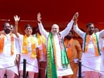 inister Amit Shah and BJP Medak candidate, Raghunandan Rao hold hands during a public meeting, in Medak on Thursday (Amit Shah-Xm)