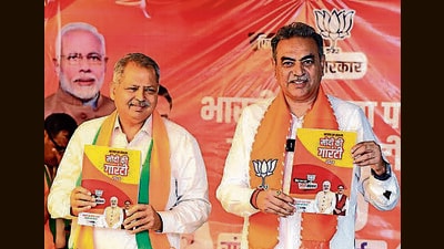 Chandigarh BJP candidate Sanjay Tandon and local party chief Jatinder Pal Malhotra launching the party manifesto at a hotel in Sector 43 on Thursday. (Keshav Singh/HT) Chandigarh BJP candidate Sanjay Tandon and local party chief Jatinder Pal Malhotra launching the party manifesto at a hotel in Sector 43 on Thursday. (Keshav Singh/HT)