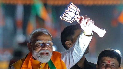 Prime Minister Narendra Modi greets his supporters during a roadshow (AFP) Prime Minister Narendra Modi greets his supporters during a roadshow (AFP)
