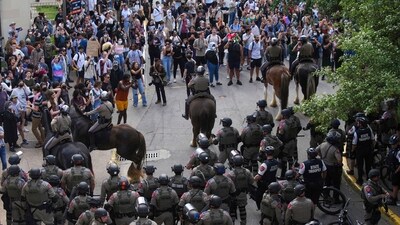 Pro-Palestinian protesters are pushed to the edge of campus by Texas State Troopers on horses at the University of Texas Wednesday, April 24, 2024, in Austin, Texas.&nbsp; (AP)