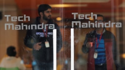 Tech Mahindra Q4 results: Employees walk outside the cafeteria in the Tech Mahindra office building in Noida on the outskirts of New Delhi. (Reuters)