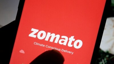 The logo of food delivery company Zomato is seen on its app on a mobile phone displayed in front of its company website. (Reuters)