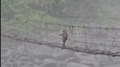 Police personnel crossing the bridge in Arunachal Pradesh after repolling. (Instagram/@AllIndiaRadio) Police personnel crossing the bridge in Arunachal Pradesh after repolling. (Instagram/@AllIndiaRadio)