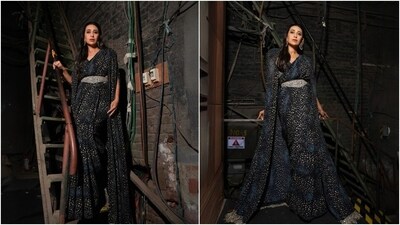 Karisma's black georgette saree features a rosette print in a beige shade. She wore the six yards in traditional style, with the pallu on the shoulder and the front tucked in neat pleats. She wore the saree with a matching sleeveless blouse featuring a plunging neckline, silver embroidery under the bust, and a fitted silhouette.&nbsp; (Instagram)