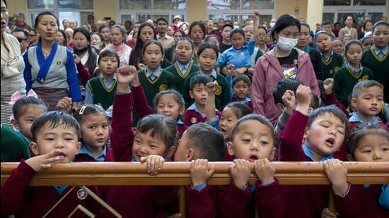 Exile Tibetan children recite the Tibetan national anthem at an event marking the birthday of the 11th Panchen Lama, Gendhun Choekyi Nyima, in Dharamshala, on April 25. The young lama went missing shortly after his recognition by the Dalai Lama in 1995 and has not been seen since. (AP)