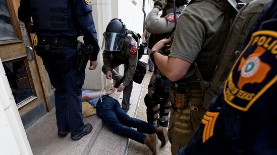 A man is detained as pro-Palestinian protesters demonstrate at the University of Texas, during the ongoing conflict between Israel and the Palestinian Islamist group Hamas, in Austin, Texas, U.S. April 24, 2024. REUTERS/Nuri VallbonaTexas(REUTERS)
