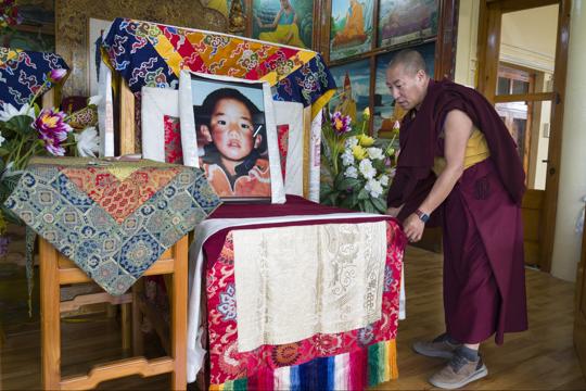 An exile Tibetan Buddhist monk puts a scarf in front of a portrait of the 11th Panchen Lama, Gendhun Choekyi Nyima, at an event marking his birthday in Dharamshala (AP) An exile Tibetan Buddhist monk puts a scarf in front of a portrait of the 11th Panchen Lama, Gendhun Choekyi Nyima, at an event marking his birthday in Dharamshala (AP)