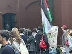 A Viral image shows an anti-Israel protester at GWU holding a ‘final solution’ sign (@zach_kessel/X)