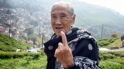 An elderly voter shows her ink-marked finger after voting at a polling station in Darjeeling, West Bengal. (ANI) An elderly voter shows her ink-marked finger after voting at a polling station in Darjeeling, West Bengal. (ANI)