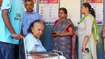 A volunteer assists an elderly woman in a wheelchair at a polling station in Bengaluru, Karnataka. (Shailendra Bhojak / PTI) A volunteer assists an elderly woman in a wheelchair at a polling station in Bengaluru, Karnataka. (Shailendra Bhojak / PTI)