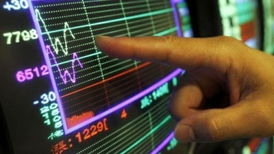 A securities manager points to a fluctuating stock indicator in Taipei, Taiwan. Stock markets in Asia were mixed with investment sentiment on the wane amid Europe's ongoing debt crisis.