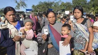 Bru tribal women show their identity card as they wait to cast their vote at a polling station (File Photo) Bru tribal women show their identity card as they wait to cast their vote at a polling station (File Photo)