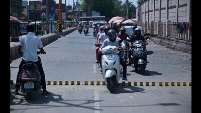 Commuters blatantly crossing over the tyre crusher near Awadh crossing. (HT)