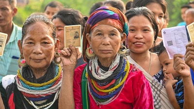 Bru (ethnic group) people show their ID cards as they wait to cast their votes for the second phase of Lok Sabha elections, at a special polling centre set up about 170 Km away from Agartala, (PTI)