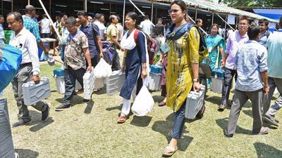 Polling staff carry EVMs to booths on the eve of the second phase of the 2024 general elections in Morigaon, Assam. (ANI Photo) Polling staff carry EVMs to booths on the eve of the second phase of the 2024 general elections in Morigaon, Assam. (ANI Photo)
