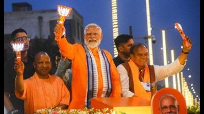 Prime Minister Narendra Modi with UP chief minister Yogi Adityanath and others during an election campaign road show amid the ongoing Lok Sabha elections, in Bareilly, Friday. (PTI Photo)