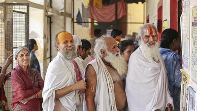 Sadhus wait in a queue to cast their votes in Mathura. (PTI PHOTO) Sadhus wait in a queue to cast their votes in Mathura. (PTI PHOTO)