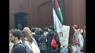A Viral image shows an anti-Israel protester at GWU holding a ‘final solution’ sign (@zach_kessel/X)