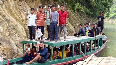 Voters on their way to polling station to cast their votes via boat for the second phase of Lok Sabha Polls at Korbuk in East Tripura on Friday. (ANI) Voters on their way to polling station to cast their votes via boat for the second phase of Lok Sabha Polls at Korbuk in East Tripura on Friday. (ANI)