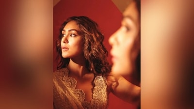 To add the perfect finishing touches, she styled her long luscious tresses into soft curls and left it open in the middle partition to let them beautifully cascade down her shoulder and complement her glamorous look. (Instagram/@mrunalthakur) To add the perfect finishing touches, she styled her long luscious tresses into soft curls and left it open in the middle partition to let them beautifully cascade down her shoulder and complement her glamorous look. (Instagram/@mrunalthakur)