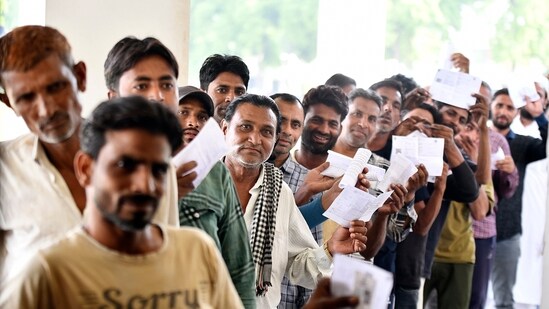Voters stand in a queue to cast their vote at a polling station during the second phase of the Lok Sabha Polls, at Dadri in Gautam Buddha Nagar District, Uttar Pradesh on Friday. (ANI)