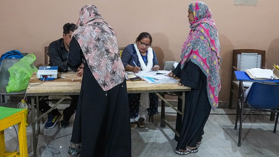 Women go through the election procedure before casting their votes for the second phase of Lok Sabha elections in Meerut.(PTI)