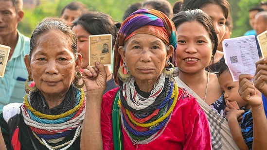 Bru (ethnic group) people show their ID cards as they wait to cast their votes for the second phase of Lok Sabha elections, at a special polling centre set up about 170 Km away from Agartala, (PTI)
