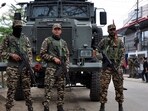 Security personnel stand guard in front of their armoured vehicle in Imphal, Manipur. (Reuters)