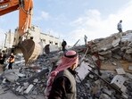 A passerby looks on as Palestinians inspect the site of an Israeli strike on a house, amid the ongoing conflict between Israel and the Palestinian Islamist group Hamas, in Rafah, in the southern Gaza Strip, April 21, 2024.(REUTERS)