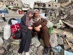 Palestinian women react as they sit on the rubble of a residential building housing their apartments, following an Israeli raid, amid the ongoing conflict between Israel and the Palestinian Islamist group Hamas, in Nuseirat, in the central Gaza Strip, April 18, 2024. REUTERS/Doaa Rouqa     TPX IMAGES OF THE DAY