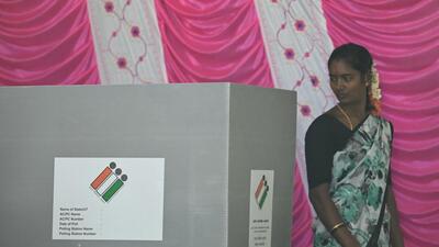 A voter leaves after casting her vote at a polling station in Bengaluru on Friday. (AFP) A voter leaves after casting her vote at a polling station in Bengaluru on Friday. (AFP)